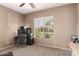 Cozy bedroom featuring neutral paint, a ceiling fan, gray carpet, and a bright window at 2945 E Clifton Ave, Gilbert, AZ 85295