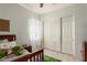 Bedroom featuring light blue walls, closet, and a window with white curtains at 2945 E Clifton Ave, Gilbert, AZ 85295