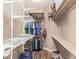 Walk-in closet with hanging clothes, wire and wooden shelving, and assorted storage items at 2945 E Clifton Ave, Gilbert, AZ 85295