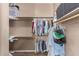 Walk-in closet with hanging clothes on rods, shelves, and assorted storage items at 2945 E Clifton Ave, Gilbert, AZ 85295