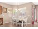 Bright dining room with a white table, chandelier, slider and multiple windows at 2945 E Clifton Ave, Gilbert, AZ 85295