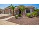 Beautiful home with desert landscaping, palm trees, and a well-maintained front yard at 2945 E Clifton Ave, Gilbert, AZ 85295