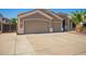 Spacious three-car garage with extended driveway, desert landscaping, and well-maintained home exterior at 2945 E Clifton Ave, Gilbert, AZ 85295