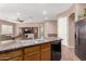 Modern kitchen features an island with a sink, granite countertops, and stainless steel appliances at 2945 E Clifton Ave, Gilbert, AZ 85295
