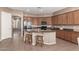 Open kitchen features granite countertops, an island with seating, and stainless steel appliances at 2945 E Clifton Ave, Gilbert, AZ 85295