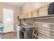Functional laundry room with washer, dryer, and ample storage at 2945 E Clifton Ave, Gilbert, AZ 85295