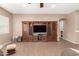 Open-concept living room with tile flooring, natural light, and an attractive built-in entertainment center at 2945 E Clifton Ave, Gilbert, AZ 85295