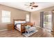 Serene main bedroom with hardwood floors, ceiling fan, patio access, and an ensuite bathroom at 2945 E Clifton Ave, Gilbert, AZ 85295