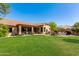 Expansive backyard featuring mature landscaping, exterior home views and covered outdoor seating area at 29506 N 21St Ave, Phoenix, AZ 85085