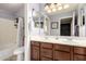Bathroom featuring double sinks, a bath and shower combination and neutral accents at 29506 N 21St Ave, Phoenix, AZ 85085