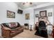 Bedroom with ceiling fan, a seating area, and decorated walls at 29506 N 21St Ave, Phoenix, AZ 85085