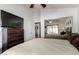 Well-appointed bedroom featuring a mirrored closet, wooden dresser, and large television at 29506 N 21St Ave, Phoenix, AZ 85085
