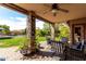 Inviting covered patio with comfortable seating and views of the beautifully landscaped backyard and pool at 29506 N 21St Ave, Phoenix, AZ 85085