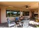 Outdoor living space featuring comfortable seating, ceiling fan, and views of the sparkling pool at 29506 N 21St Ave, Phoenix, AZ 85085