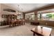 Dining room featuring a vaulted ceiling, a large table, and natural light from expansive windows at 29506 N 21St Ave, Phoenix, AZ 85085