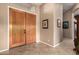 Spacious entryway with double doors, tile flooring, and elegant wall decor at 29506 N 21St Ave, Phoenix, AZ 85085