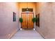 Inviting entryway featuring double doors, decorative plants, and a stylish overhead light fixture at 29506 N 21St Ave, Phoenix, AZ 85085