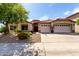 Charming home featuring a tile roof, desert landscaping, and a spacious three-car garage at 29506 N 21St Ave, Phoenix, AZ 85085