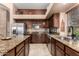 This spacious kitchen has dark wood cabinets, stainless steel appliances, and granite countertops at 29506 N 21St Ave, Phoenix, AZ 85085