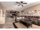 Open-concept living room with a leather sofa and an arched doorway leading to the kitchen at 29506 N 21St Ave, Phoenix, AZ 85085