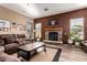 Comfortable living room showcasing a stone fireplace, wood flooring, and a plush leather sofa at 29506 N 21St Ave, Phoenix, AZ 85085