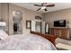 This main bedroom has a ceiling fan and a view into the main bathroom at 29506 N 21St Ave, Phoenix, AZ 85085