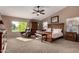 Bright and airy main bedroom with large window, ceiling fan, and private seating area at 29506 N 21St Ave, Phoenix, AZ 85085
