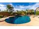 Inviting backyard pool with mature trees, a waterfall feature, and diving board at 29506 N 21St Ave, Phoenix, AZ 85085