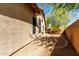 Side yard featuring low maintenance gravel landscaping and an exterior wall at 29506 N 21St Ave, Phoenix, AZ 85085
