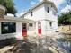 Backyard showing a white two-story home with red doors and a concrete patio at 3215 W Orangewood Ave, Phoenix, AZ 85051