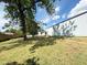 Spacious, shaded backyard with lush grass and mature trees, great for outdoor activities at 3215 W Orangewood Ave, Phoenix, AZ 85051