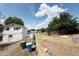 Backyard view of a two-story house featuring a fenced yard, a dirt driveway, and trash cans at 3215 W Orangewood Ave, Phoenix, AZ 85051