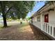 Exterior of the home showing a long porch with climbing vines and a well-manicured lawn at 3215 W Orangewood Ave, Phoenix, AZ 85051