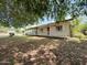 A cozy home with a front porch, surrounded by mature trees and greenery at 3215 W Orangewood Ave, Phoenix, AZ 85051
