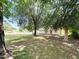 A cozy home with a white picket fence and front porch, surrounded by mature trees and greenery at 3215 W Orangewood Ave, Phoenix, AZ 85051