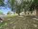 A cozy home with a white picket fence and front porch, surrounded by mature trees and greenery at 3215 W Orangewood Ave, Phoenix, AZ 85051