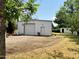 Spacious white garage/workshop, offering ample storage and workspace on a large lot at 3215 W Orangewood Ave, Phoenix, AZ 85051