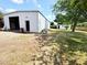 Spacious white garage with open door, set in a large yard with a charming shed at 3215 W Orangewood Ave, Phoenix, AZ 85051