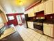 Efficient kitchen with stainless steel appliances, white cabinets, and a tiled floor at 3215 W Orangewood Ave, Phoenix, AZ 85051