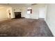 Cozy living room featuring carpet, a fireplace, a small window and neutral walls at 3215 W Orangewood Ave, Phoenix, AZ 85051
