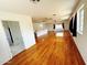 Spacious living room with hardwood floors, many windows, and a view to another room at 3215 W Orangewood Ave, Phoenix, AZ 85051