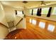 Spacious living room featuring hardwood floors, multiple windows, and ceiling fans at 3215 W Orangewood Ave, Phoenix, AZ 85051