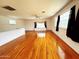 Bright living room with hardwood floors, lots of natural light, and several ceiling fans at 3215 W Orangewood Ave, Phoenix, AZ 85051
