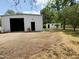 Exterior of outbuilding with trees, a chair, and a secondary building nearby at 3215 W Orangewood Ave, Phoenix, AZ 85051