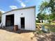 Exterior of the outbuilding with a chair and an additional building in the background at 3215 W Orangewood Ave, Phoenix, AZ 85051