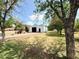 Large outbuilding or workshop with metal siding and a roll-up door, in a spacious yard at 3215 W Orangewood Ave, Phoenix, AZ 85051
