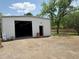 Exterior of an outbuilding and chair with trees, on a sunny day at 3215 W Orangewood Ave, Phoenix, AZ 85051
