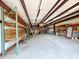 Spacious outbuilding interior with concrete floors, metal shelving, and an open design at 3215 W Orangewood Ave, Phoenix, AZ 85051