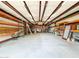 Interior of outbuilding features a concrete floor, shelving, and a rolling ladder at 3215 W Orangewood Ave, Phoenix, AZ 85051