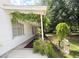 Long front porch with greenery, white columns and a vintage aesthetic at 3215 W Orangewood Ave, Phoenix, AZ 85051